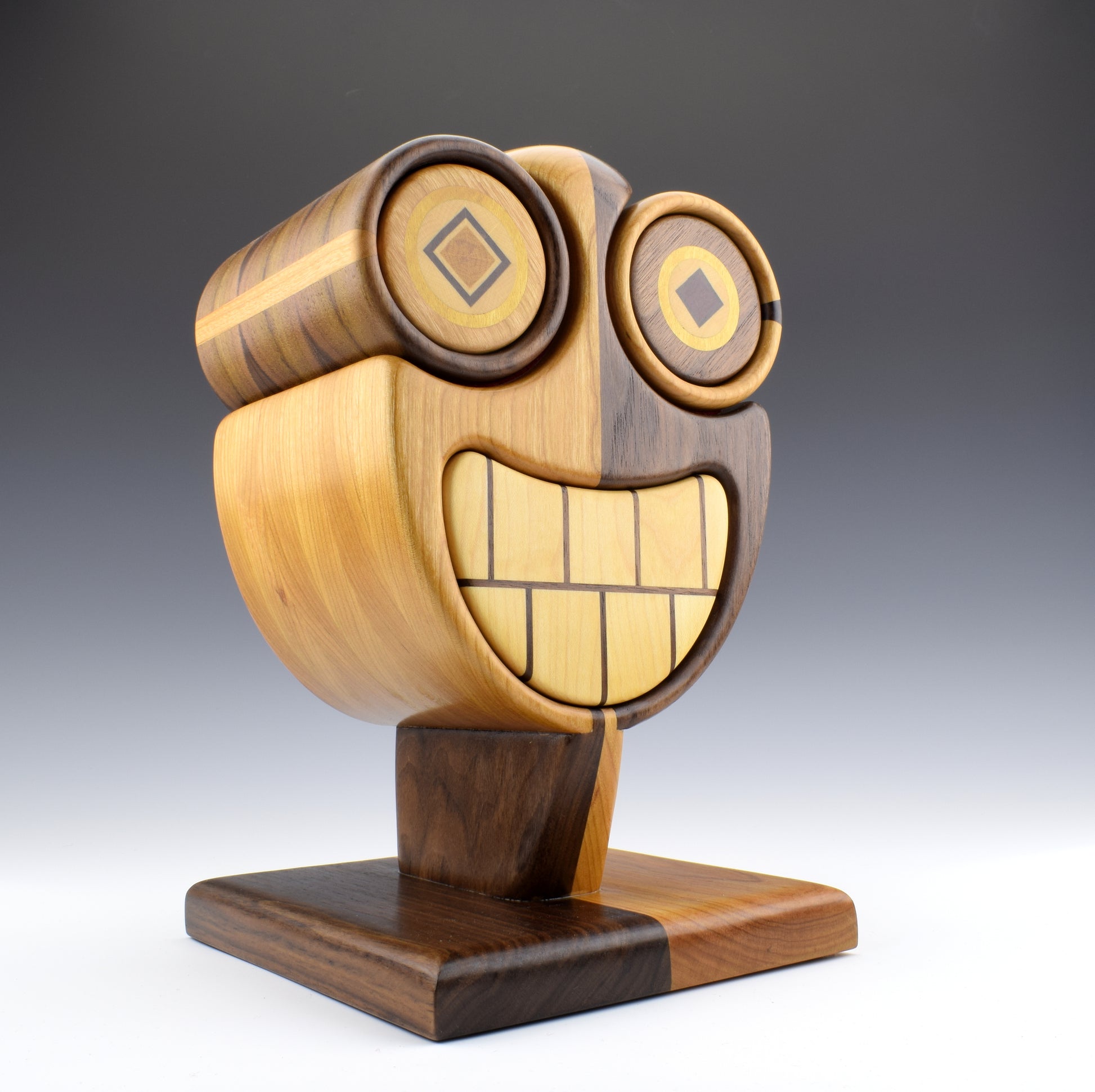 Bandsaw Box by Simon Roy. Maple smile in a walnut and cherry casing. Purpleheart and yellowheart inlayed eyes. Handcrafted in Canada by roysbox