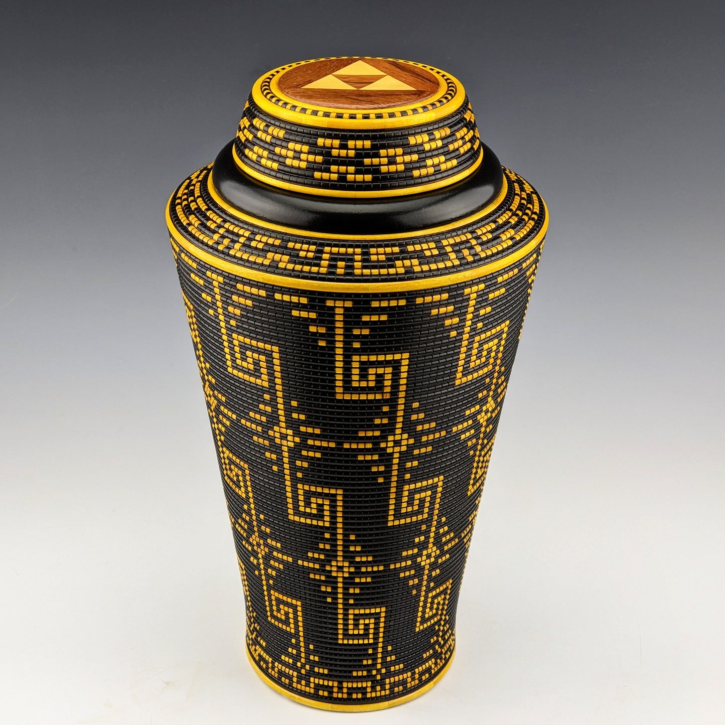 Pixel Art Vase by Simon Roy. Made of maple, ebiara, yellowheart and india ink. Features 2 hidden compartments, one inside the threaded lid and another screwed in the bottom. Handcrafted in Canada by roysbox
