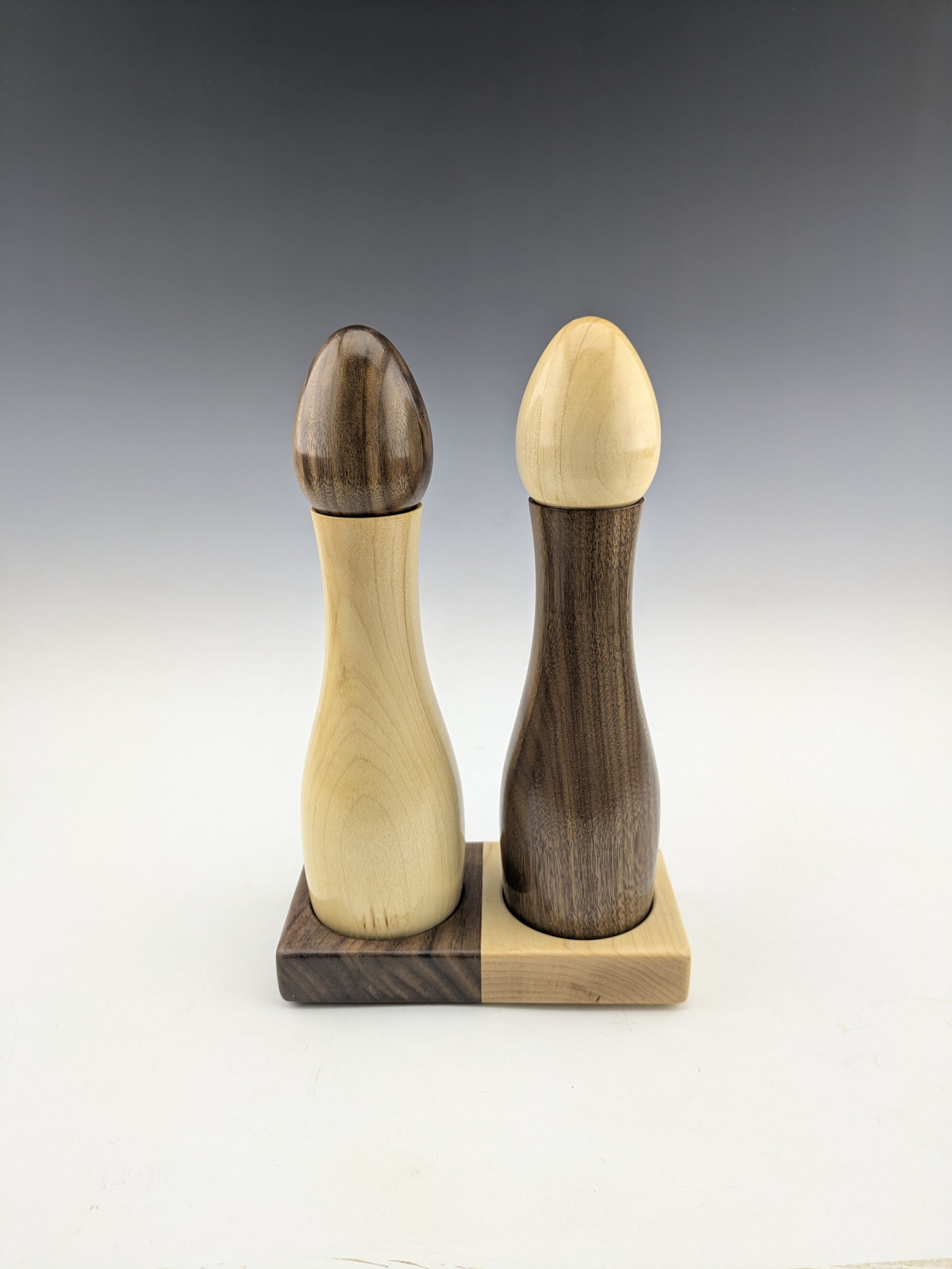 Wooden salt and pepper shakers on a matching wooden base. maple walnut. made in canada. roysbox
