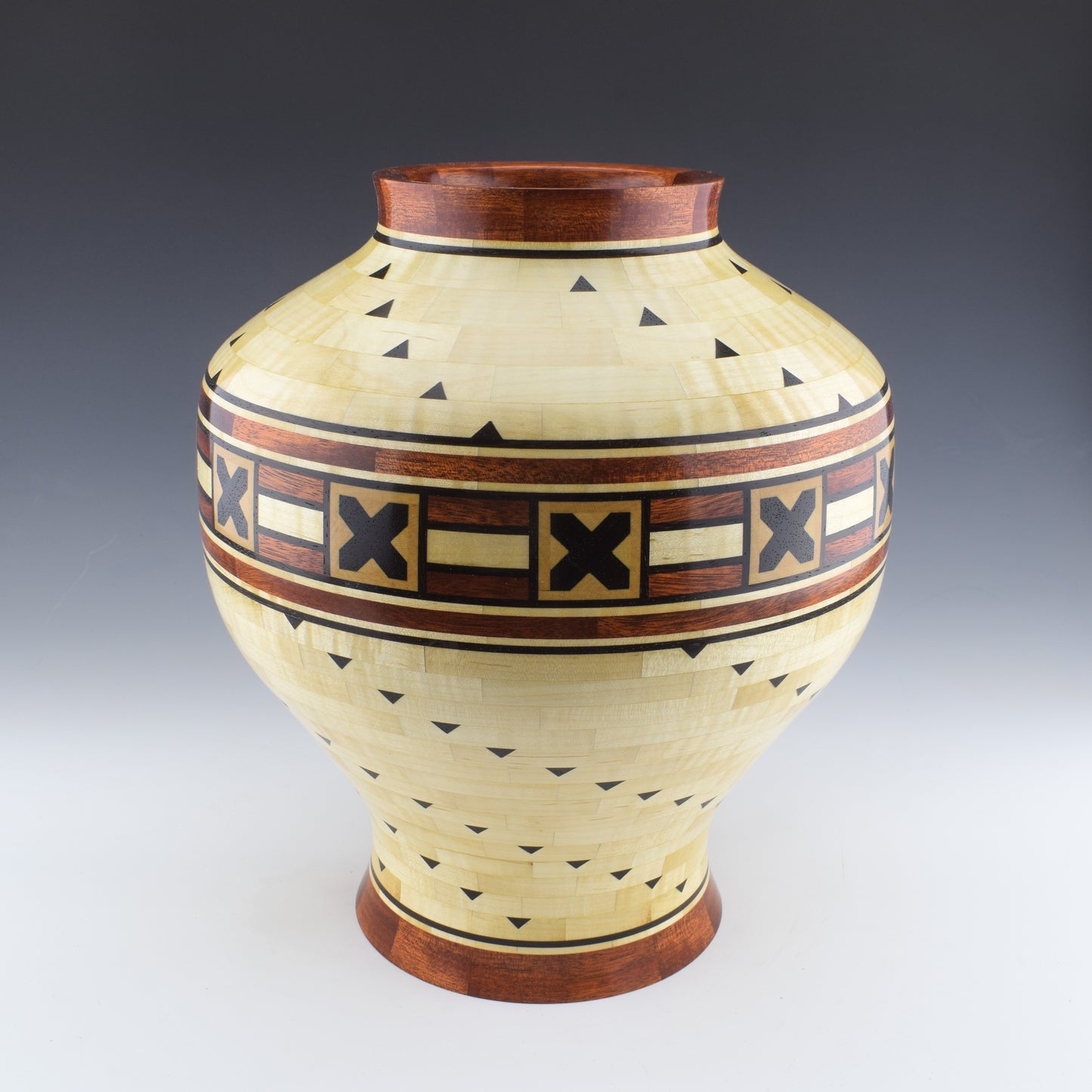 Segmented vase with a hidden box designed and Handcrafted in Canada by Simon Roy. made of curly maple, bloodwood and wenge.